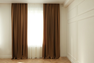 Photo of Window with elegant curtains in modern room