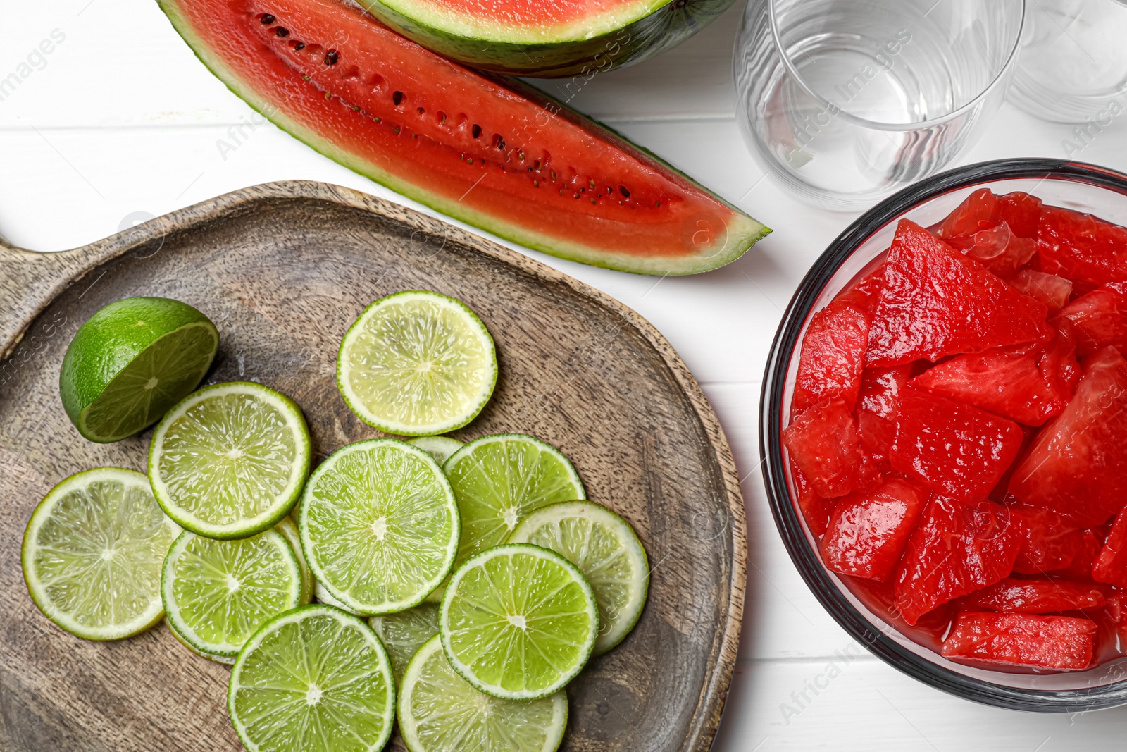 Photo of Fresh ingredients for making watermelon drink with lime on white table, above view