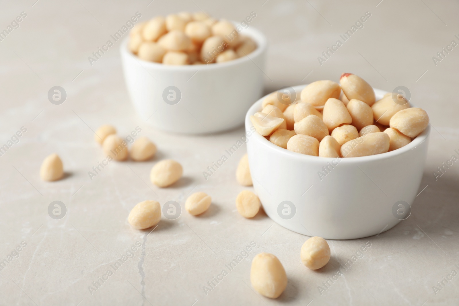 Photo of Shelled peanuts in bowl on table. Space for text