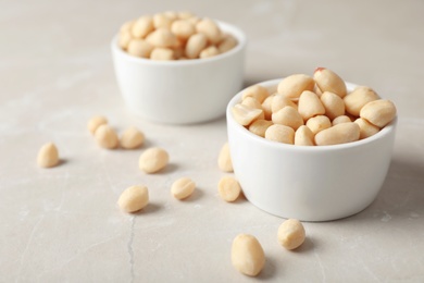 Shelled peanuts in bowl on table. Space for text