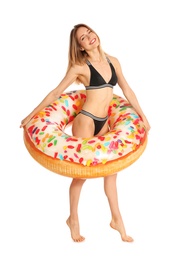 Photo of Beautiful young woman in stylish bikini with doughnut inflatable ring on white background