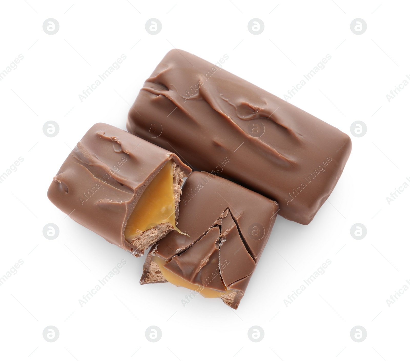 Photo of Pieces of chocolate bars with caramel on white background, top view