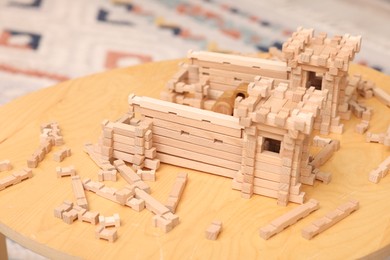 Photo of Wooden construction set on table indoors. Children's toy