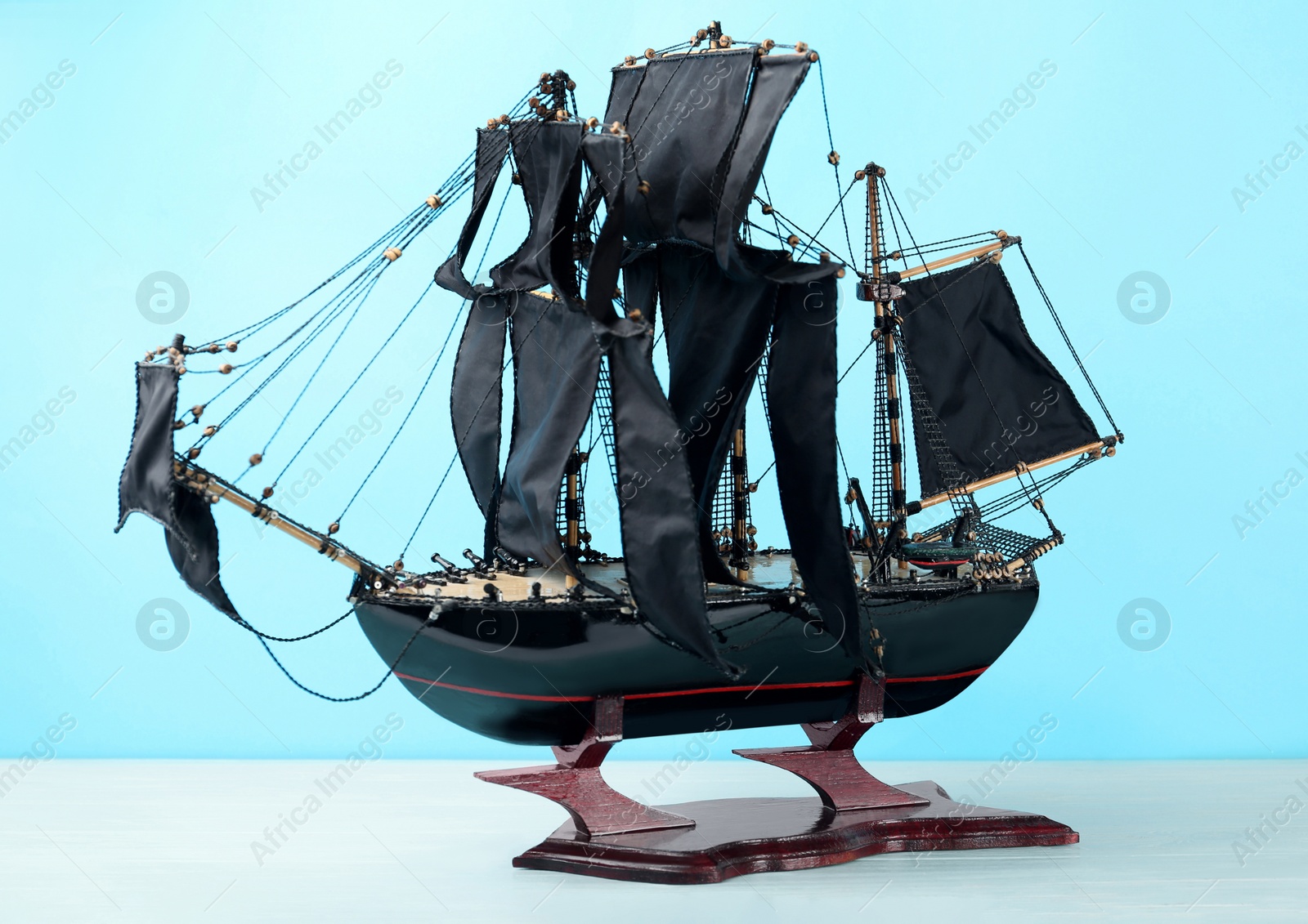 Photo of Beautiful ship model on white wooden table