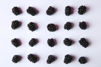 Composition with ripe blackberries on white background, top view