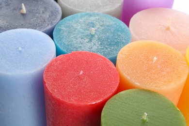 Photo of Different colorful wax candles, close up view