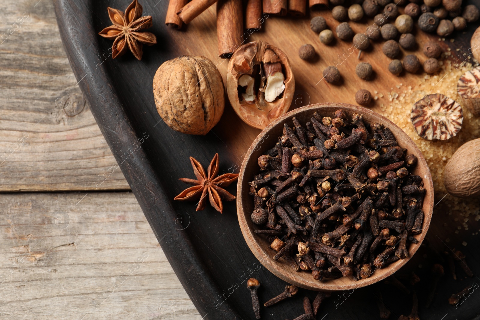 Photo of Different spices on wooden table, top view