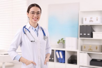 Photo of Medical consultant with glasses and stethoscope in clinic, space for text