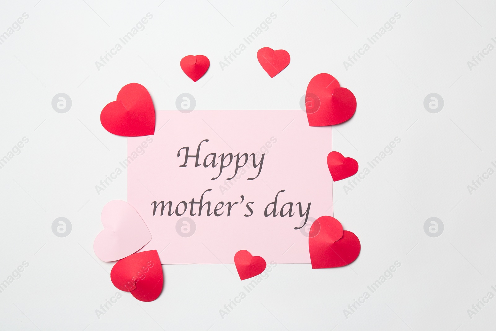 Photo of Greeting card with phrase "HAPPY MOTHER'S DAY" and paper hearts on white background