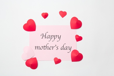 Photo of Greeting card with phrase "HAPPY MOTHER'S DAY" and paper hearts on white background