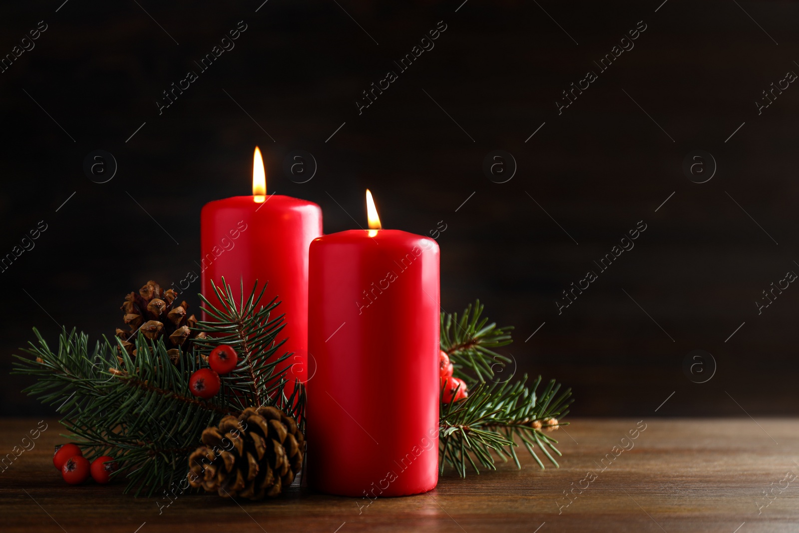 Photo of Beautiful composition with candles and Christmas decor on wooden table