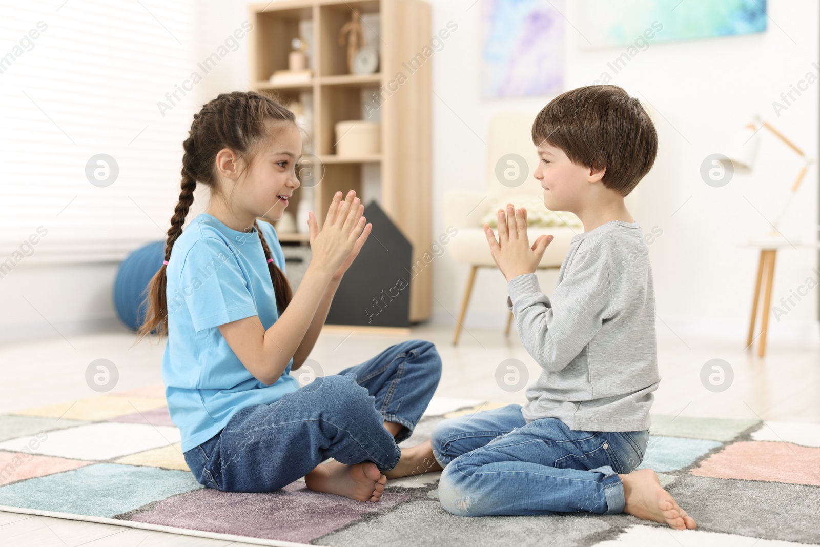 Photo of Happy brother and sister spending time together at home