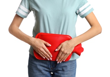 Photo of Woman using hot water bottle to relieve menstrual pain on white background, closeup