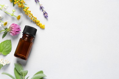 Bottle of essential oil, different herbs and flowers on white background, flat lay. Space for text