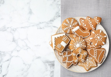 Plate with tasty homemade Christmas cookies on table, top view