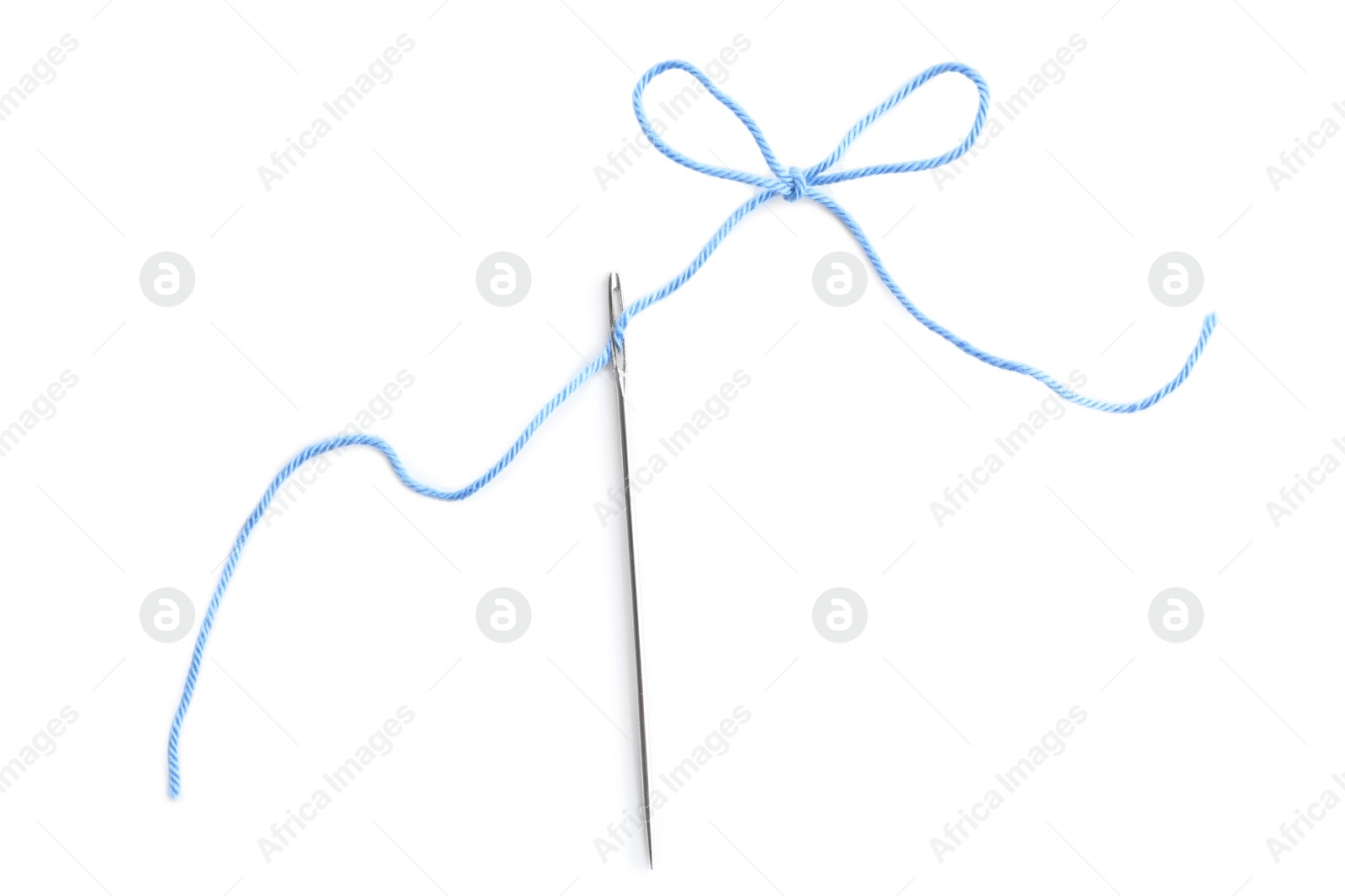 Photo of Needle with light blue sewing thread on white background, top view