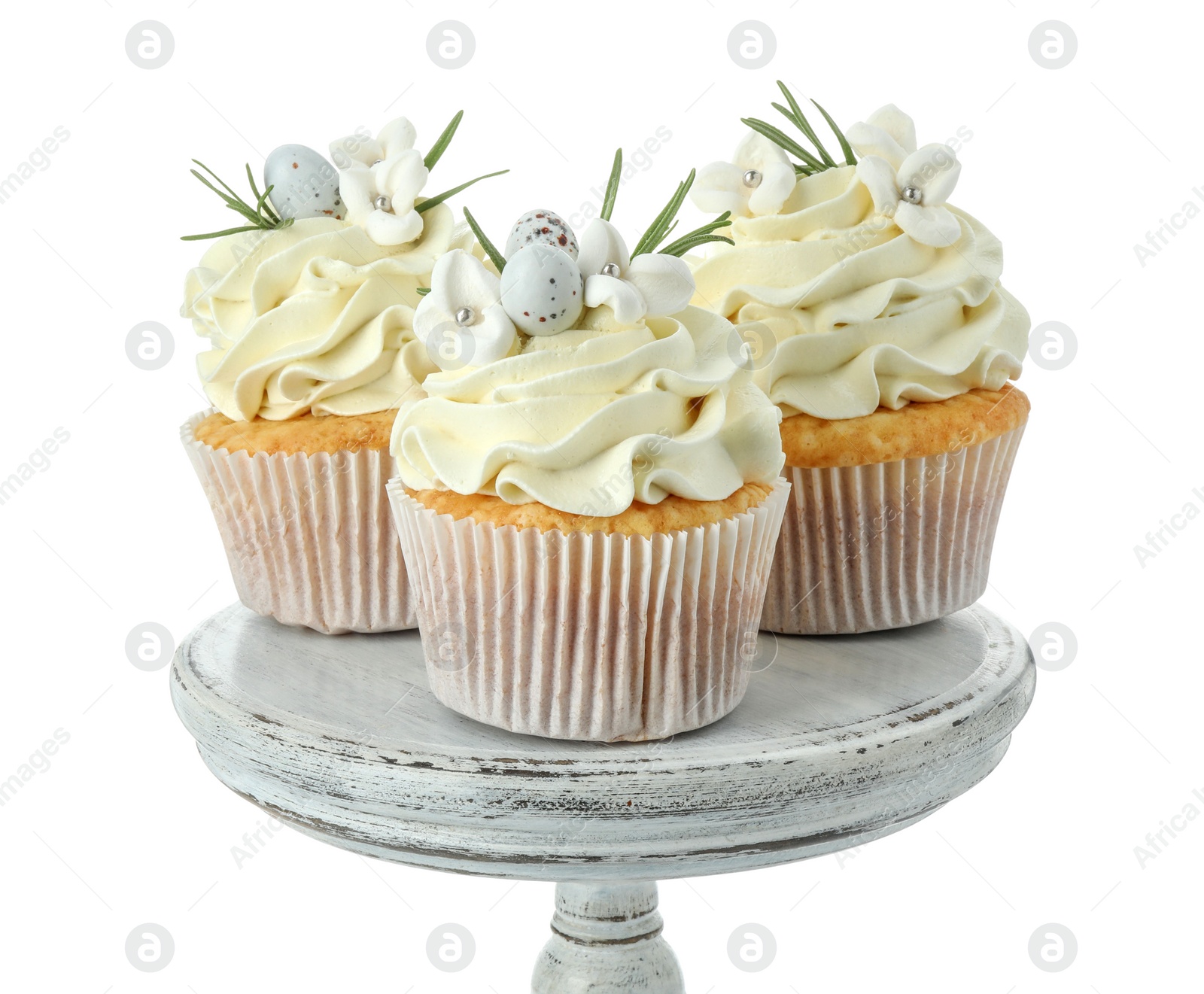 Photo of Tasty Easter cupcakes with vanilla cream isolated on white