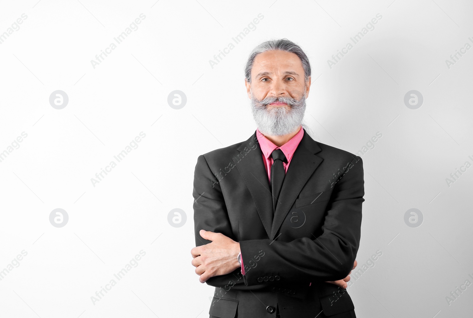 Photo of Handsome bearded mature man in suit on white background