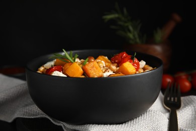 Photo of Delicious fresh chickpea salad on black table