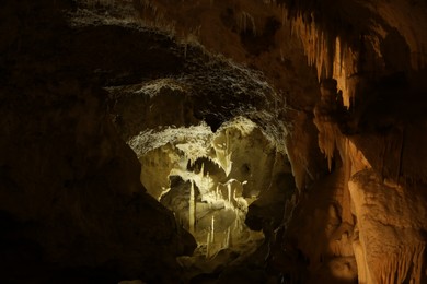 Photo of Many stalactite and stalagmite formations inside cave