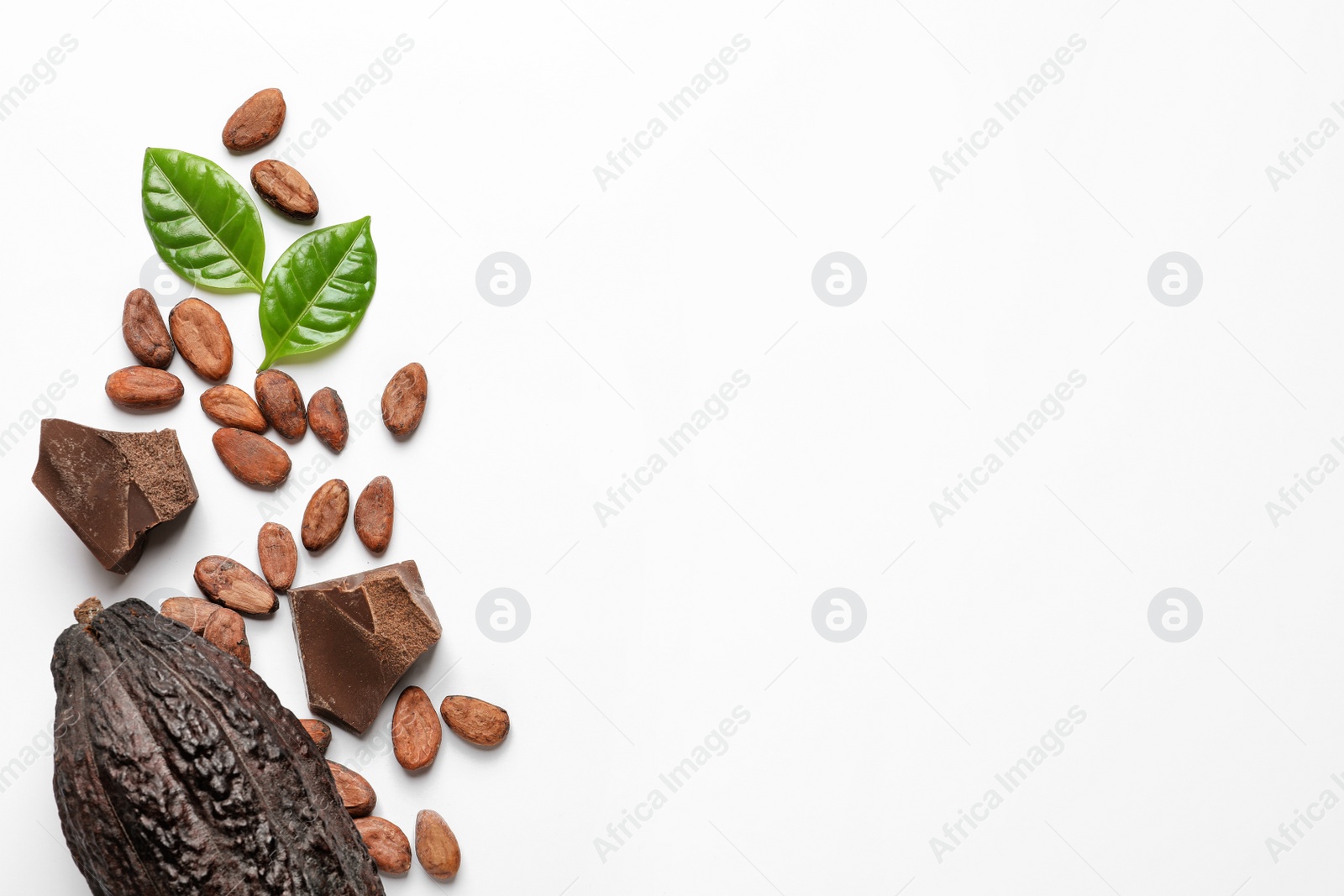 Photo of Cocoa pod with beans and chocolate pieces on white background, top view