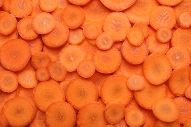 Many carrot slices as background, top view