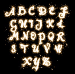 Image of Set with letters made of sparkler on black background