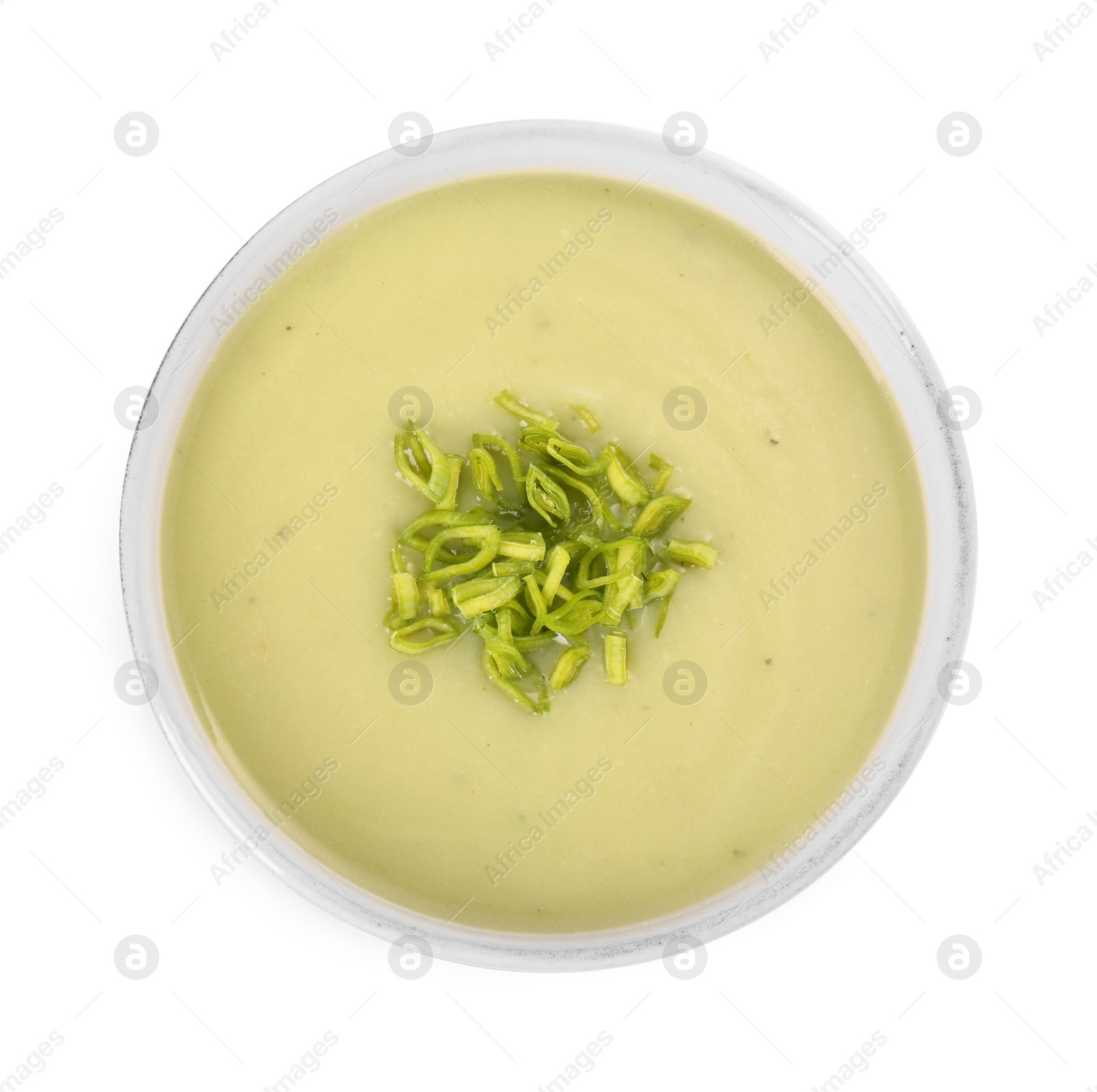 Photo of Bowl of delicious leek soup isolated on white, top view