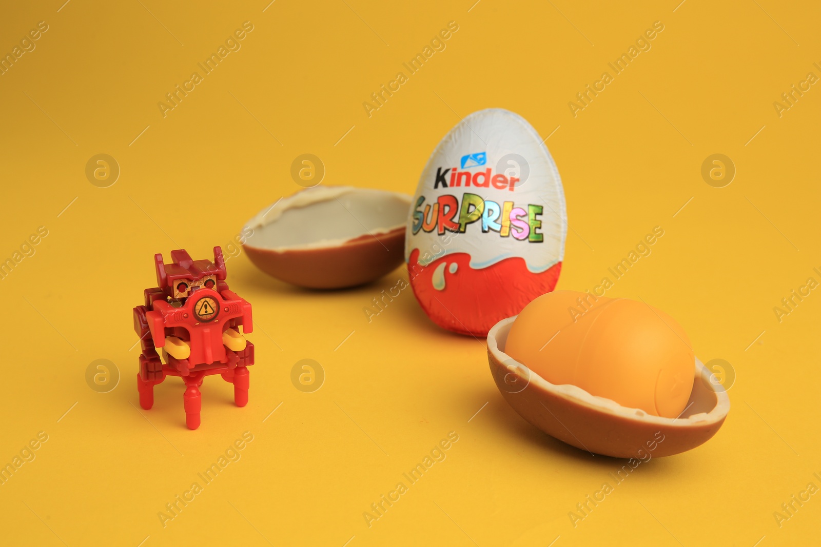 Photo of Sveti Vlas, Bulgaria - July 3, 2023: Kinder Surprise Eggs, plastic capsule and toy on yellow background