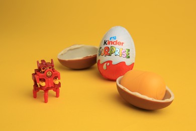 Sveti Vlas, Bulgaria - July 3, 2023: Kinder Surprise Eggs, plastic capsule and toy on yellow background
