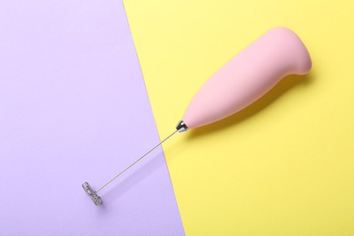 Photo of Pink milk frother wand on color background, top view