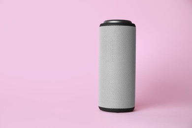 Photo of One portable bluetooth speaker on pink background, space for text. Audio equipment