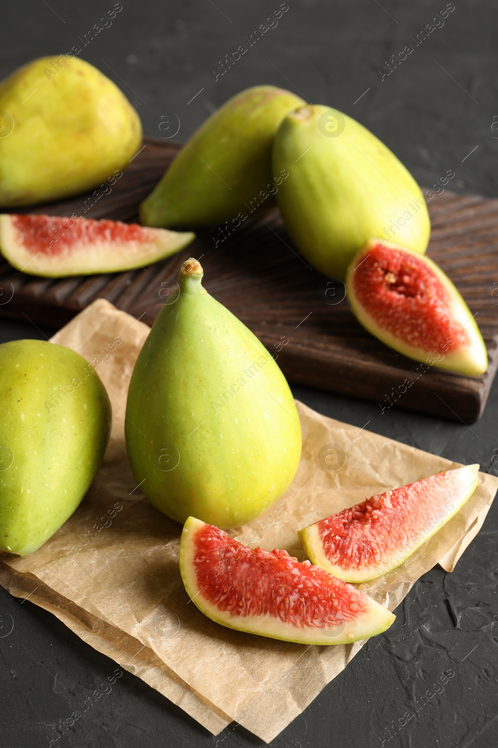 Photo of Fresh ripe figs on dark background. Tropical fruit