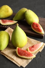 Photo of Fresh ripe figs on dark background. Tropical fruit