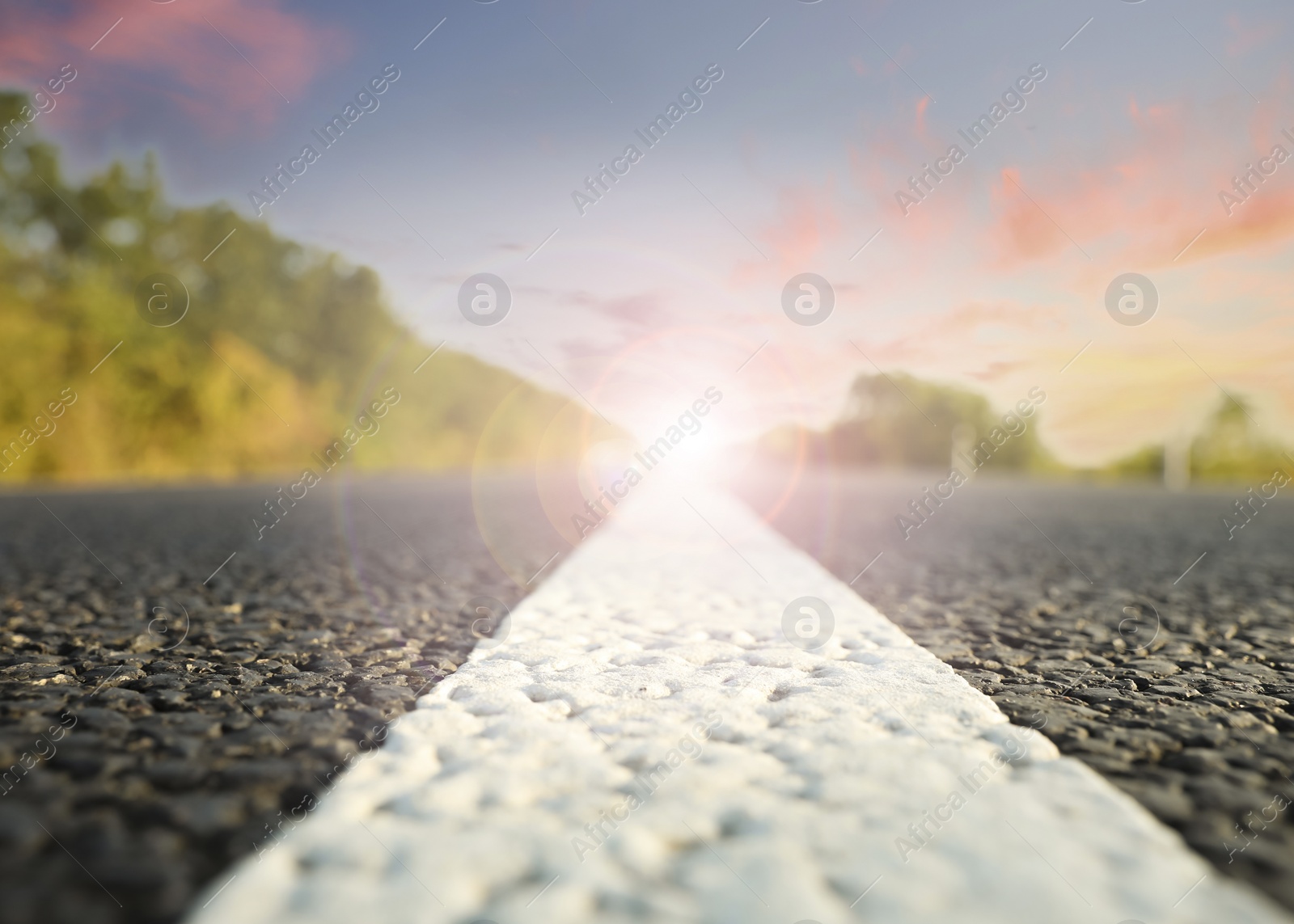 Image of Empty asphalt road at sunrise, closeup view