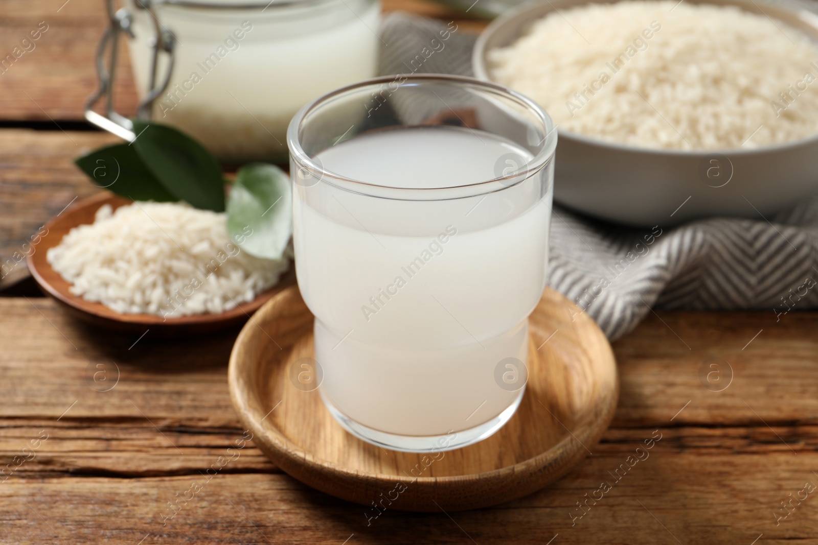 Photo of Glass of rice water on wooden table