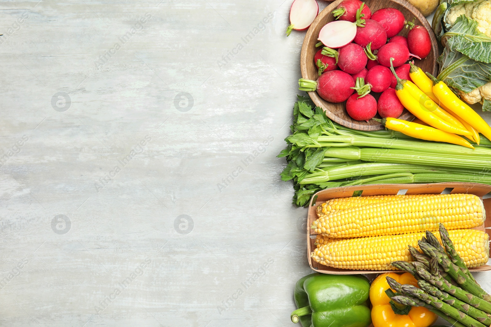 Photo of Flat lay composition with fresh vegetables and space for text on light background