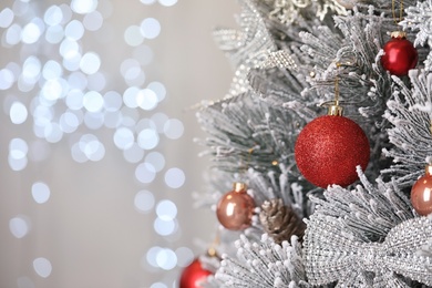 Photo of Beautiful Christmas tree with festive decor against blurred lights on background. Space for text