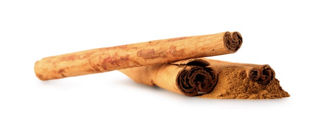 Photo of Dry aromatic cinnamon sticks and powder isolated on white