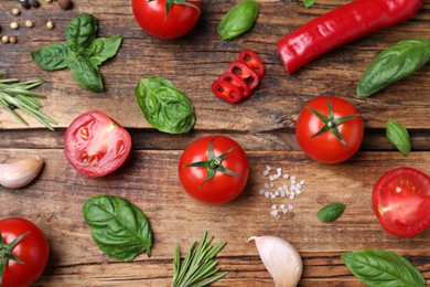 Photo of Flat lay composition with fresh green basil leaves on wooden table