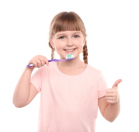 Photo of Little girl brushing teeth on white background