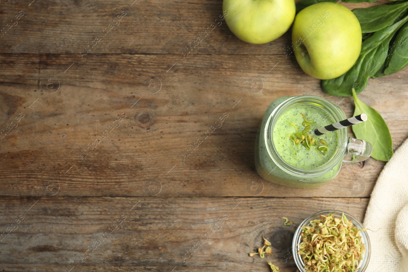 Photo of Flat lay composition with green buckwheat smoothie on wooden table, space for text