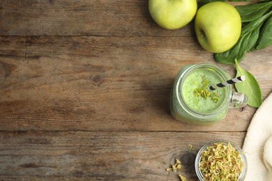 Photo of Flat lay composition with green buckwheat smoothie on wooden table, space for text