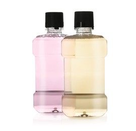 Photo of Bottles with mouthwash for teeth care on white background
