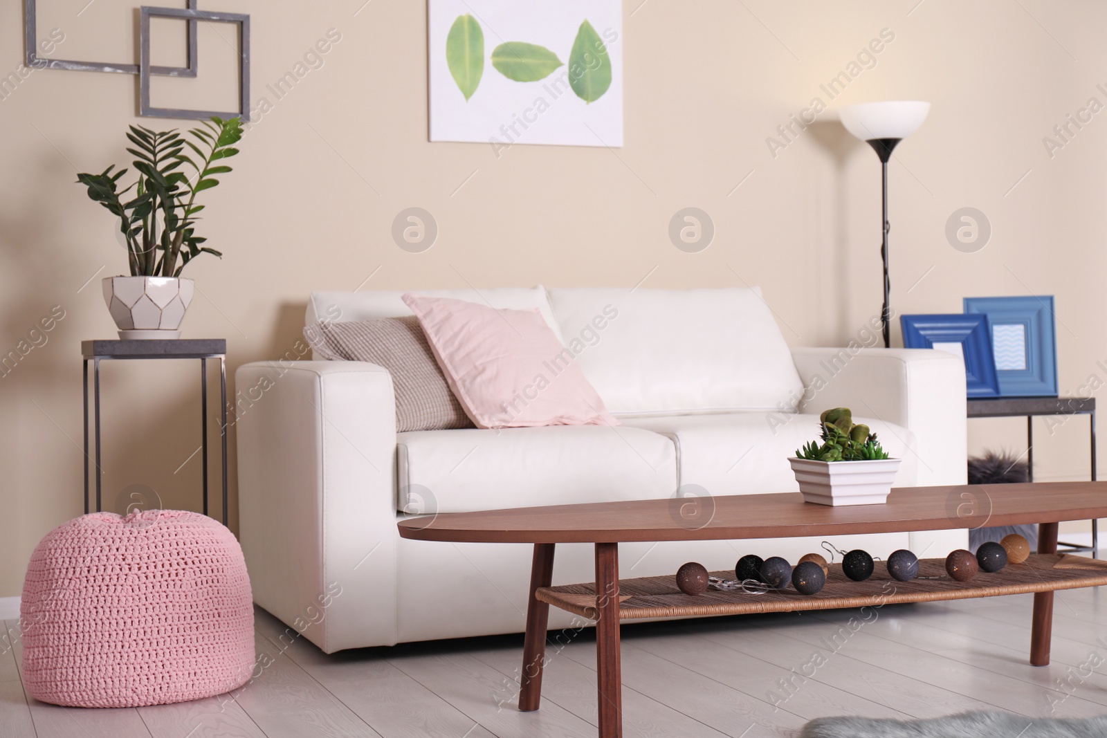 Photo of Elegant living room interior with comfortable sofa and table