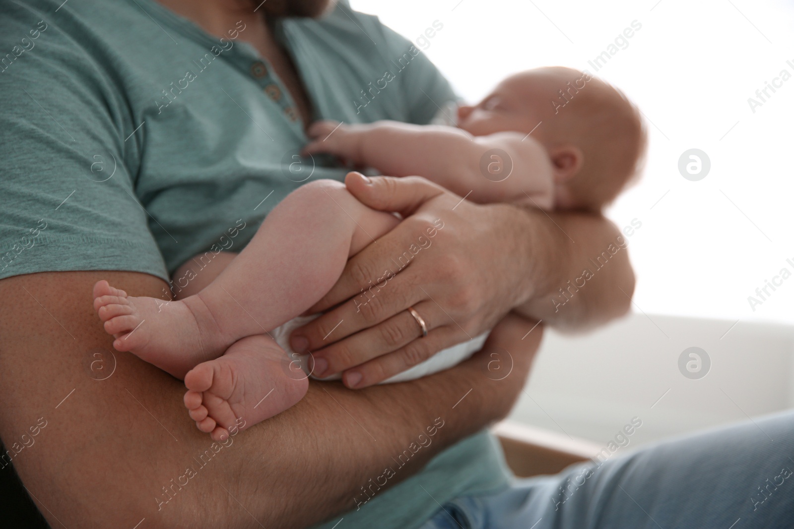 Photo of Father with his newborn son, closeup view