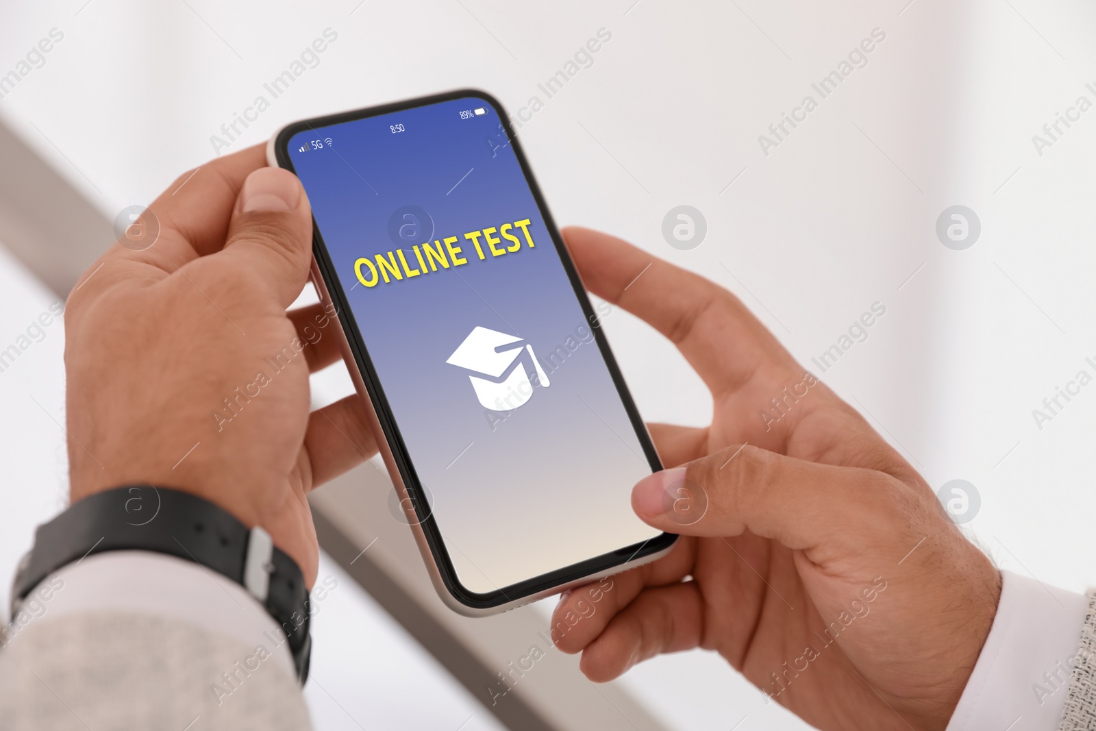 Image of Man using smartphone for online test indoors, closeup