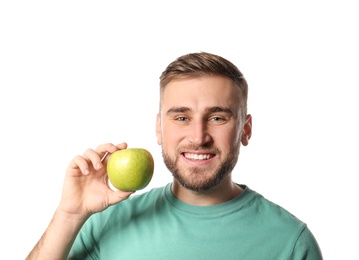 Photo of Young man with healthy teeth and apple on white background