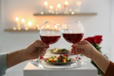 Couple having romantic dinner at home, closeup