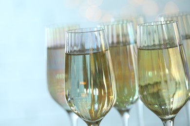 Photo of Glasses of champagne on blurred background, closeup